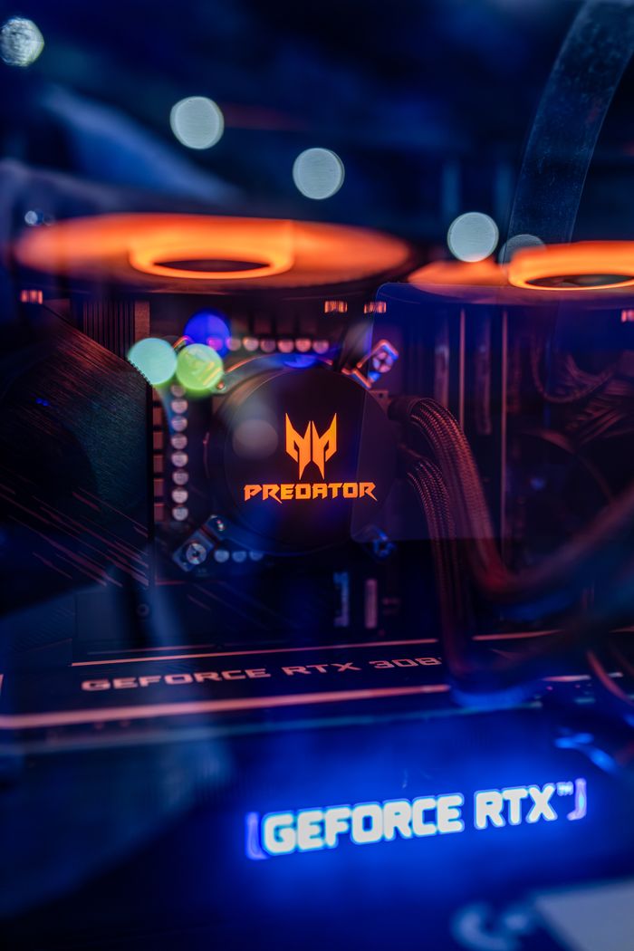 gallery-1 Close-up of a gaming PC with RTX 3080 and Predator logo featuring RGB lighting.